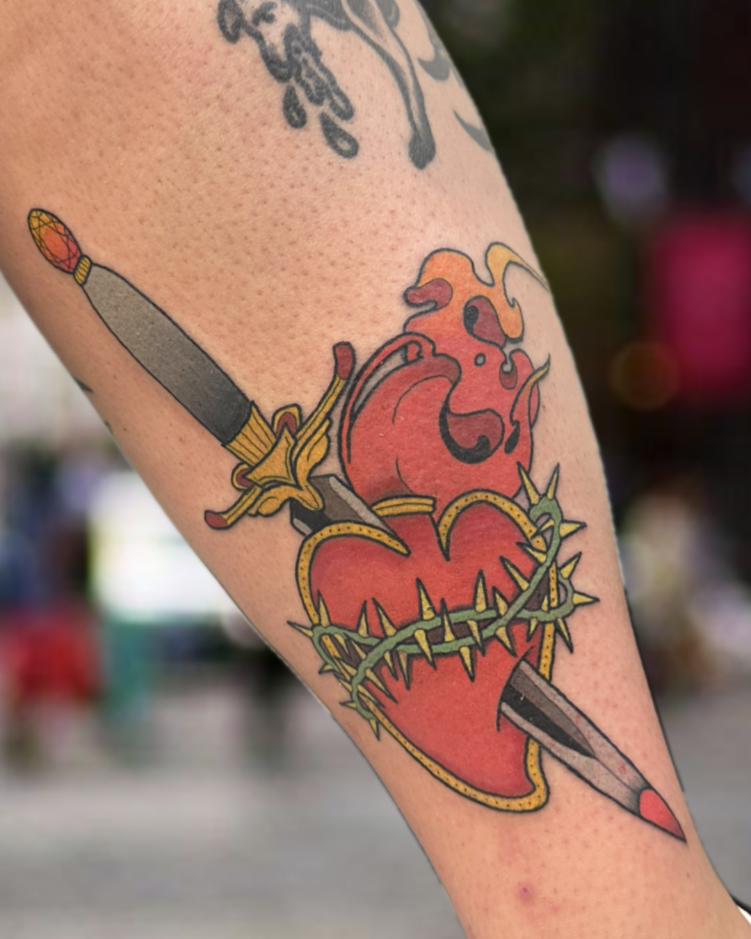 Traditional flaming sacred heart pierced by dagger tattoo