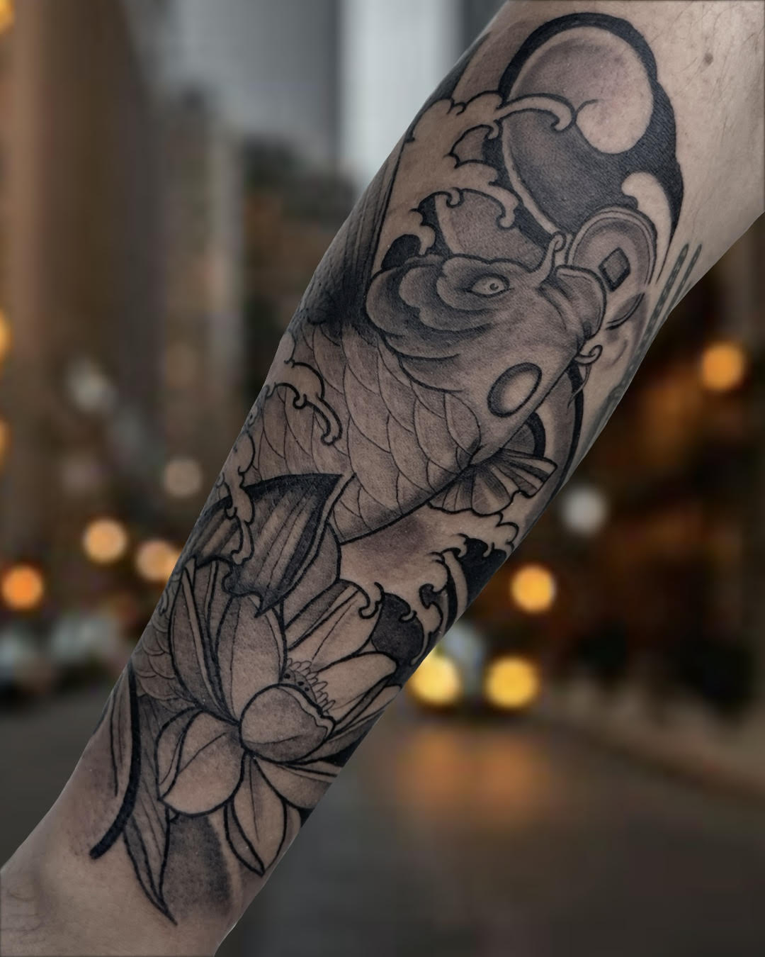 Black and grey koi fish with lotus flower sleeve tattoo