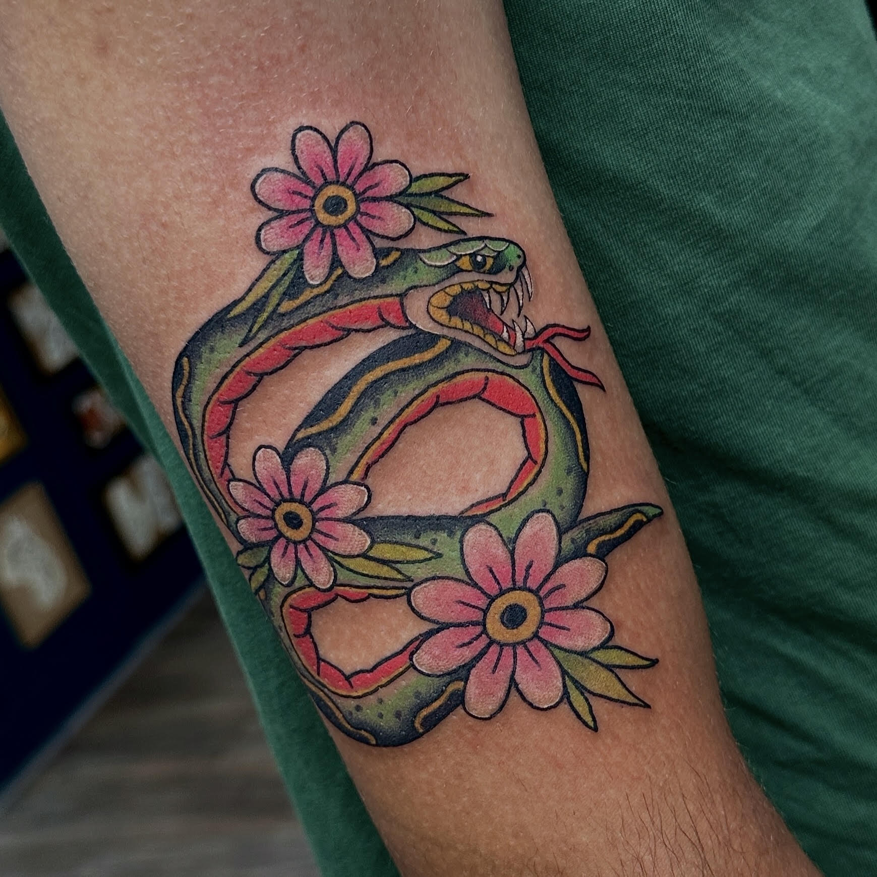 Traditional color snake with pink flowers tattoo